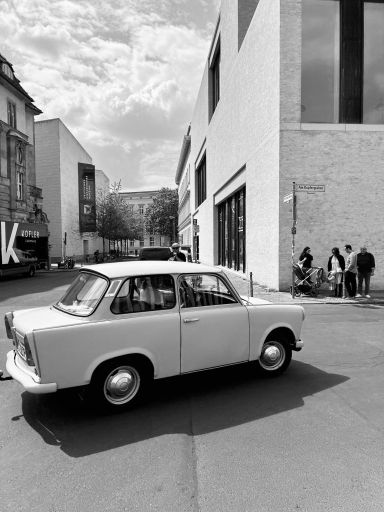 Street photography in Berlin. Photo of a car in a street. Black and white photo. 